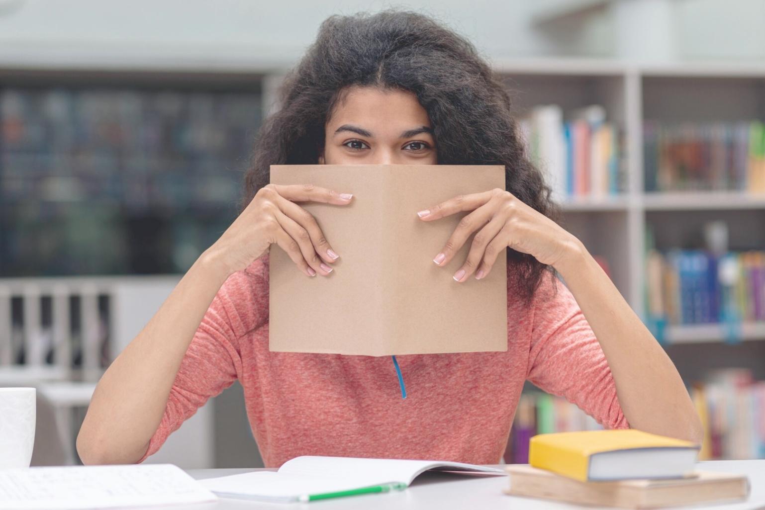 Student reviewing financial course materials and taking notes